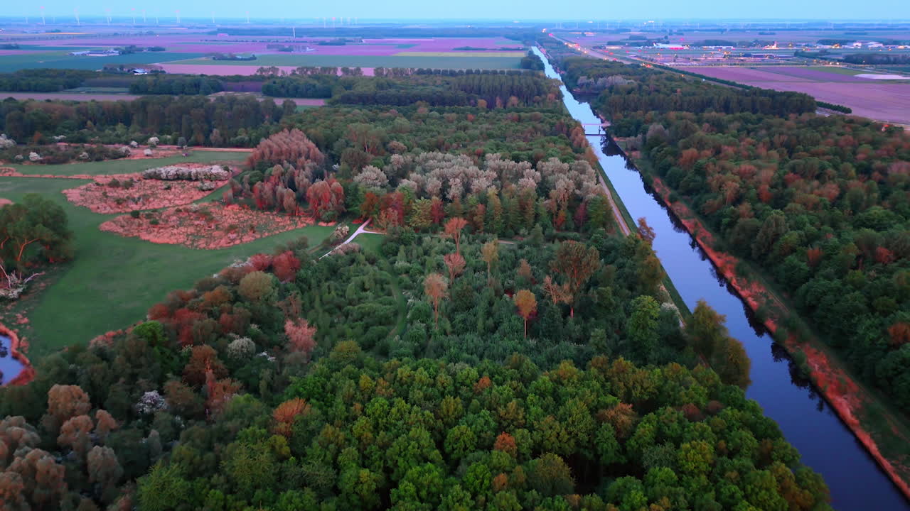 Autumn landscape with river and fields. Colorful autumn foliage lines a peaceful river while expansive fields stretch into the distance during sunset