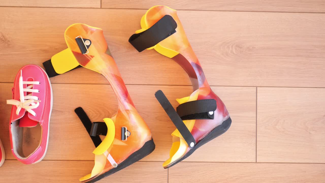 Leg Braces and Shoes on Wooden Floor