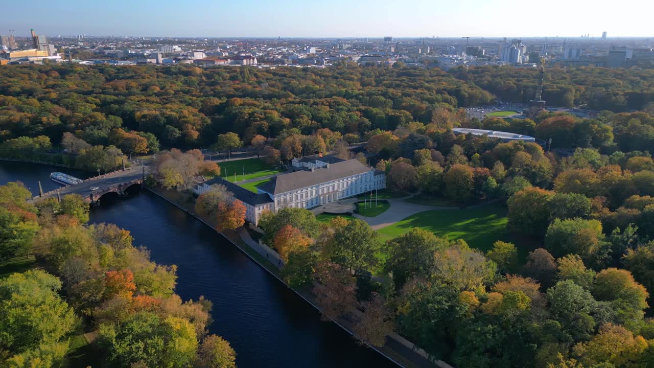 Schloss bellevue palace nestled among vibrant autumn foliage in tiergarten park, berlin, germany. panorama overview drone