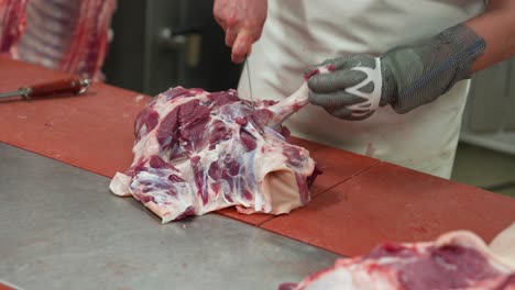 removing bones of pig carcass in slaughterhouse abattoir butchery