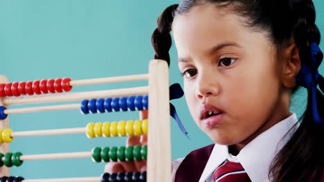 cute little girl counting on abacus