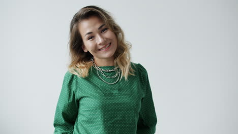 woman smiling in green polka dot shirt