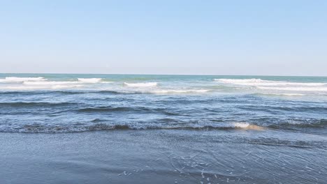 sequential view of gentle waves on a beach