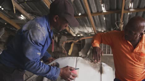 African men repairing a car