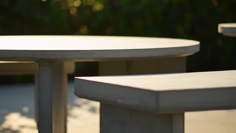 a modern concrete table set: a stylish outdoor dining experience surrounded by lush greenery, perfect for relaxing and entertaining friends or family in nature