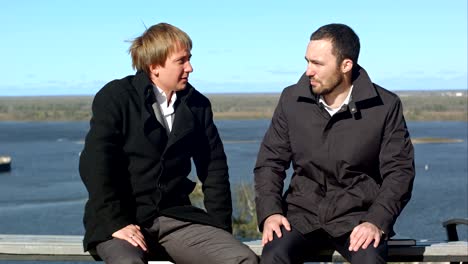 two businesspersons sitting and talking