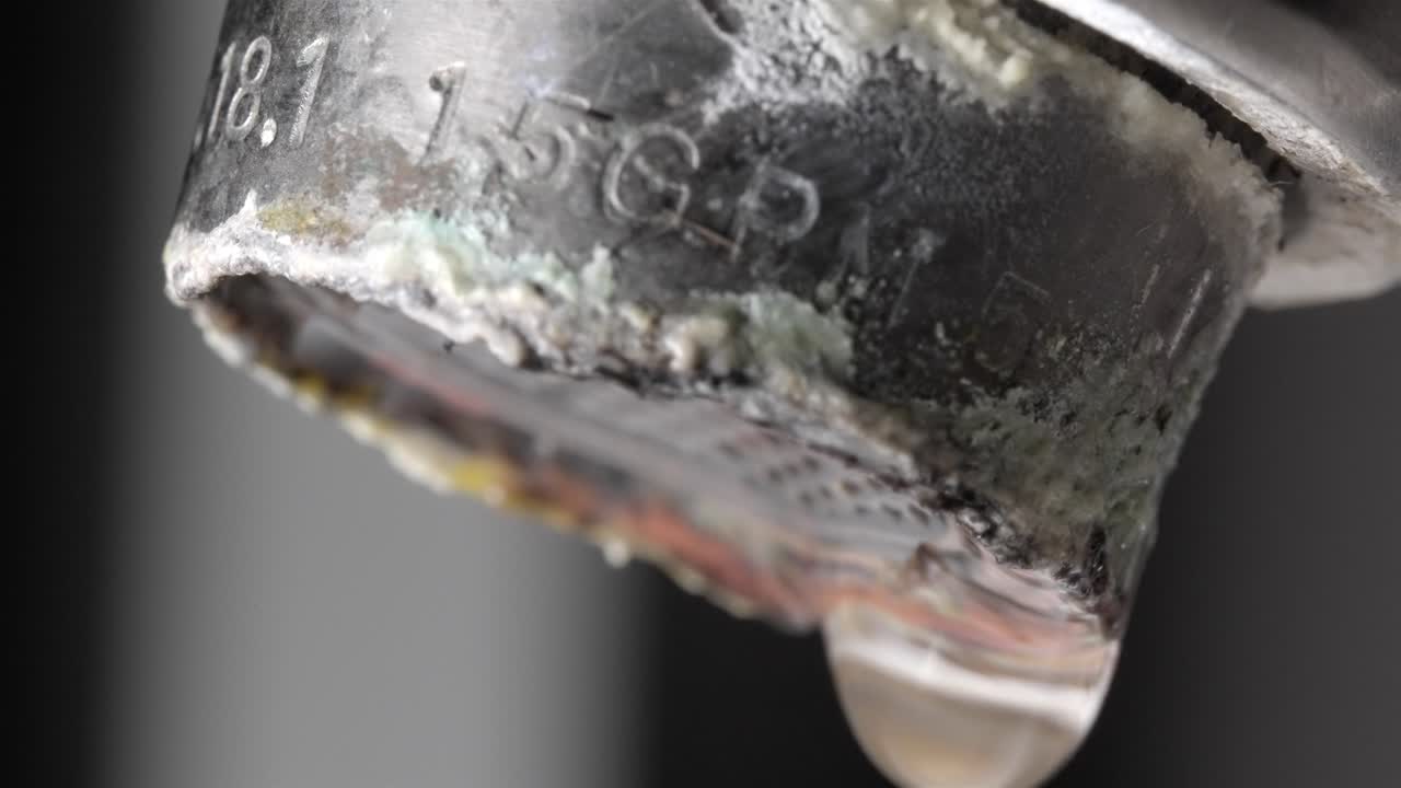 Dripping Bathroom Faucet: Macro Shot of Water Drop