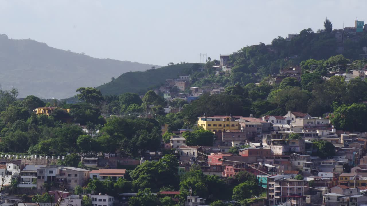 Cityscape at dusk of poor hillside neighborhoods in Tegucigalpa, Honduras. Underdevelopment.