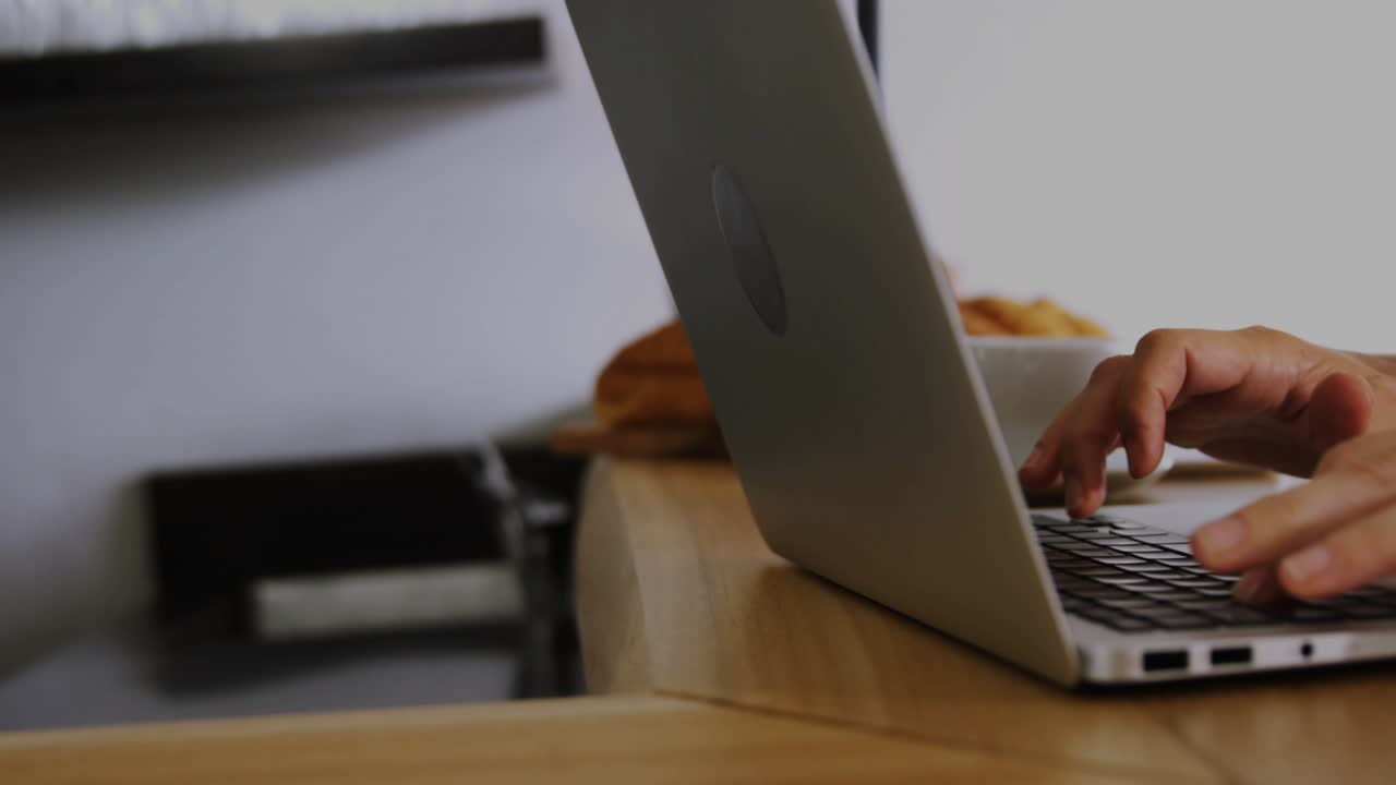Hands appearing on keyboard starting to type, HUD graphics floating onto laptop showing work status