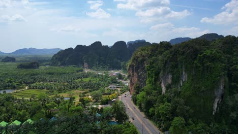 Tropical-landscape-karst-mountains-road-palm-trees