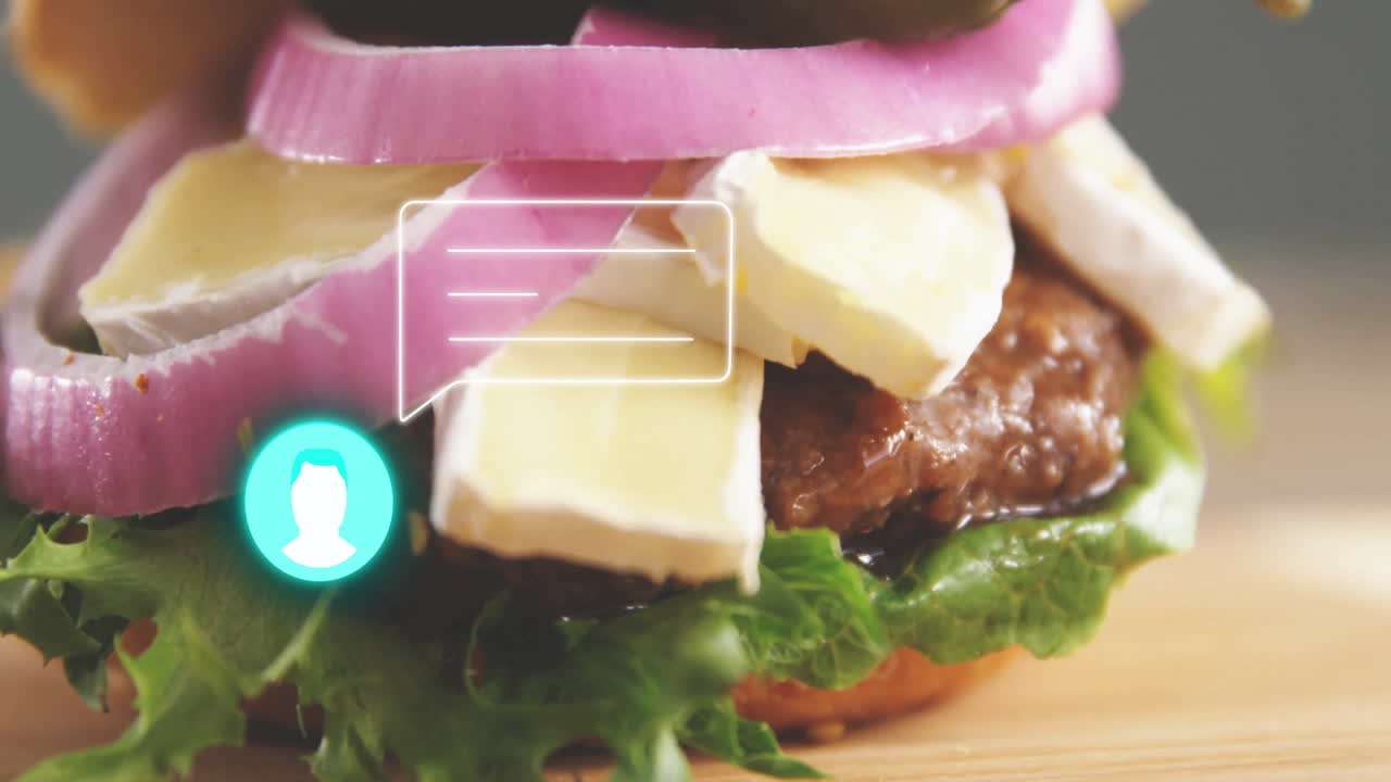 Animation of gourmet burger with lettuce, cheese, onions, chat icon overlay