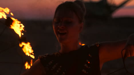 professional dancers women make a fire show and pyrotechnic performance at the festival with burning sparkling torches