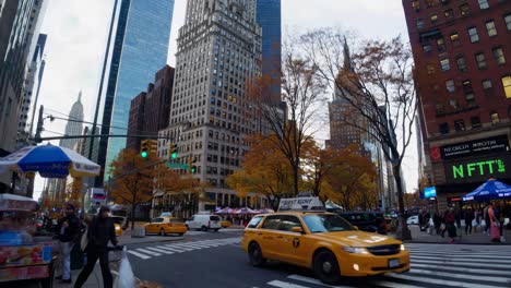 dynamic street-level video captures bustling city life with yellow taxis and skyscrapers, framed