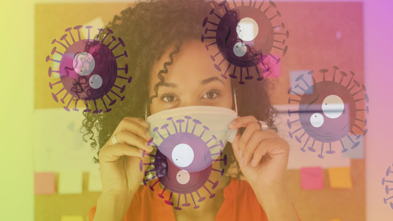múltiples células de covid-19 que se mueven contra el retrato de una mujer afroamericana con máscara facial