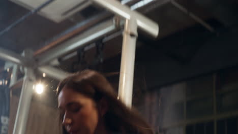 blond and brown caucasian women doing medicine ball squat throw at the gym, indoor, close up shot, handheld