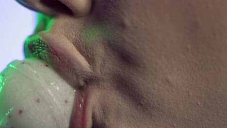 popsicle lolly on female red lips, extreme close-up of seduction concept, romance