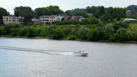 speedboat crossing on the river near rural villages near cincinnati in ohio, usa