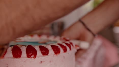 a young man prepares the cake to cut it into pieces