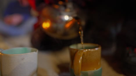 pouring tea to a glass with old kettle in slow motion - 60 fps.