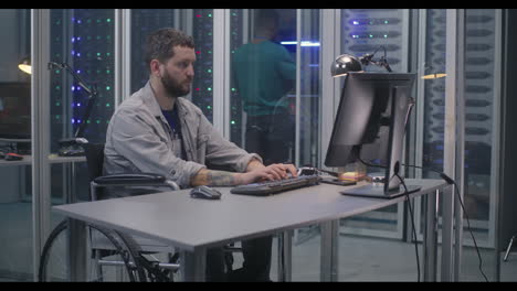 person in a wheelchair working in a server room