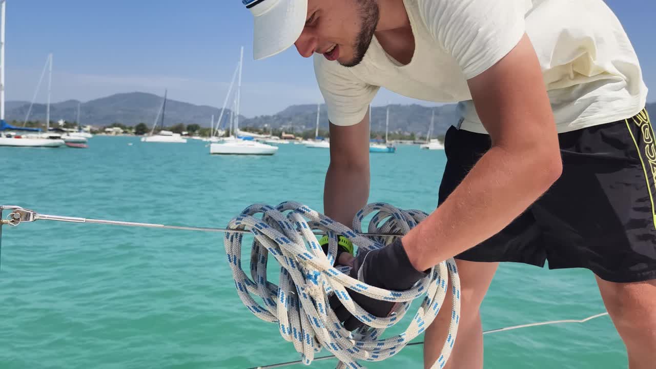 un marinero manejando una cuerda en un yate