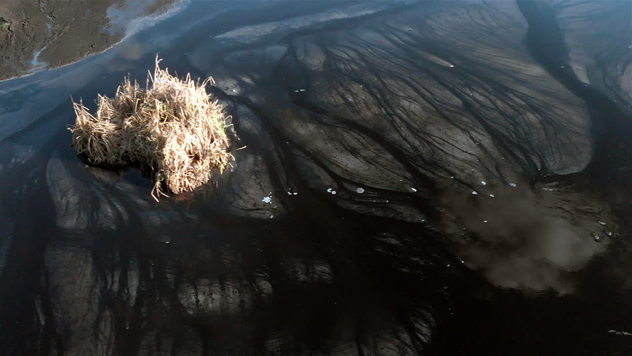 Premium stock video - The surface of the sludge lagoon