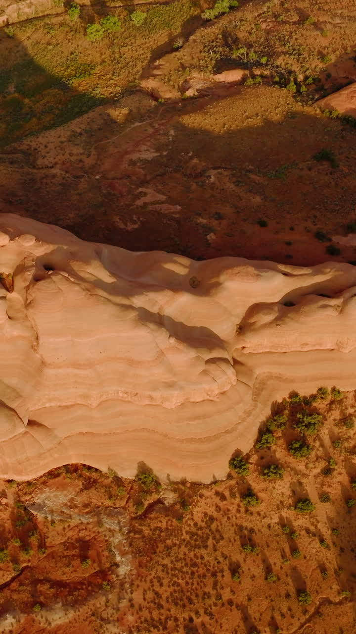 Rounded slopes of weird-shaped rock in Arches National park, Utah, USA. Aerial footage over the fantastic landscape. Vertical video