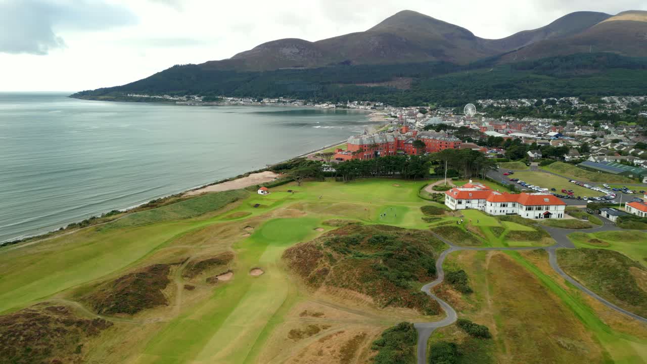 Wide, reversing aerial video of Royal County Down Golf Club in Newcastle, County Down in Northern Ireland. Filmed in 4K, 60FPS and with Rec709 color