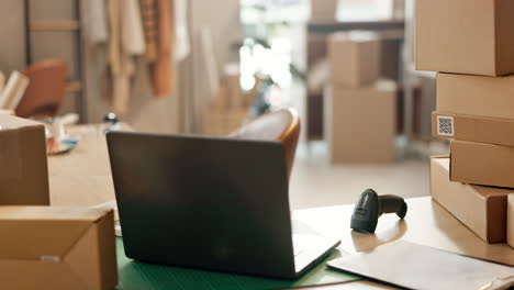 Laptop,-boxes-and-empty-warehouse-for-logistics