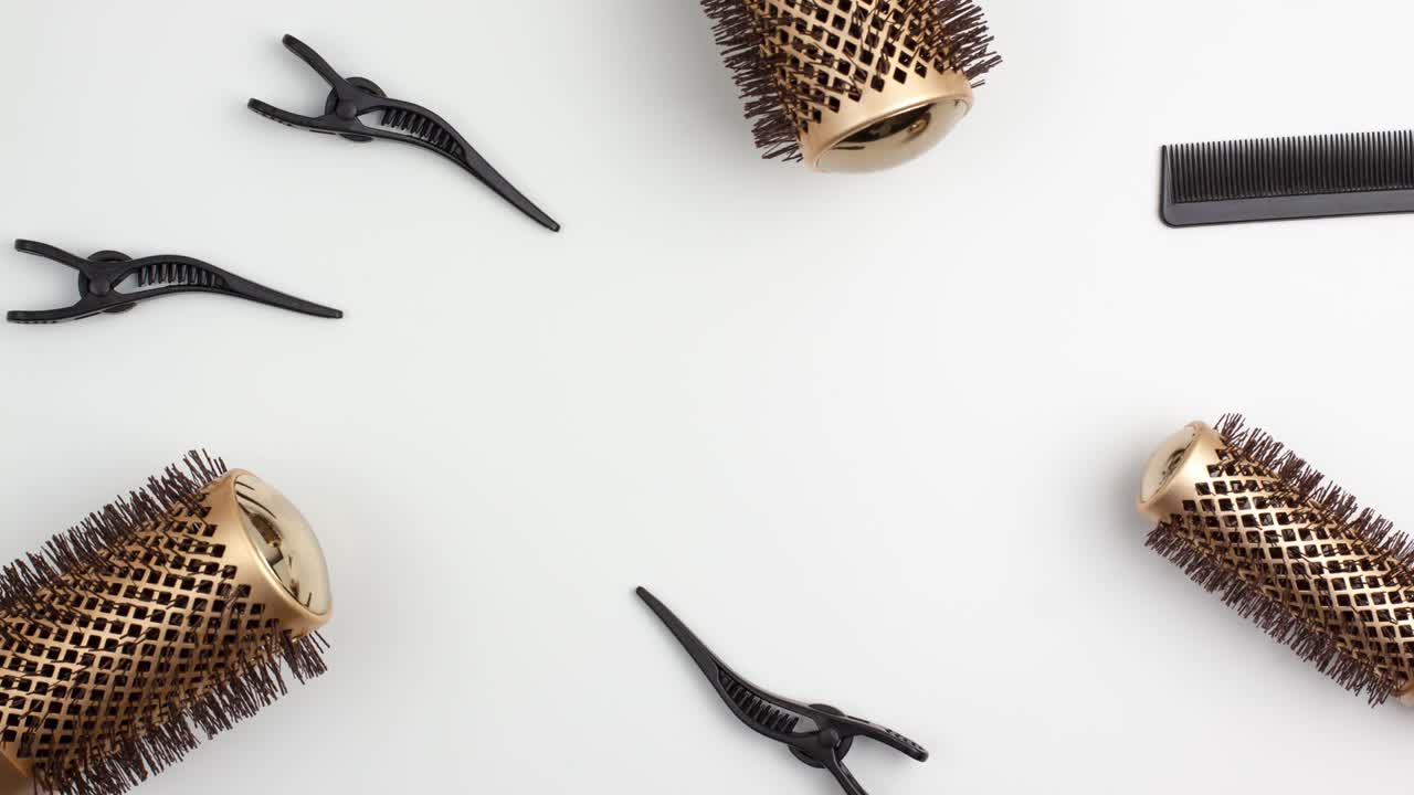 Stop motion animation of tree professional gold round hair brushes for styling,comb for separating hair and section hair clips template with copy space Hairdresser salon equipment concept, premium set