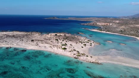 Elafonisi-beach-in-Crete-with-shallow-waters-surrounding-the-shore-of-the-half-island-with-blue-sky