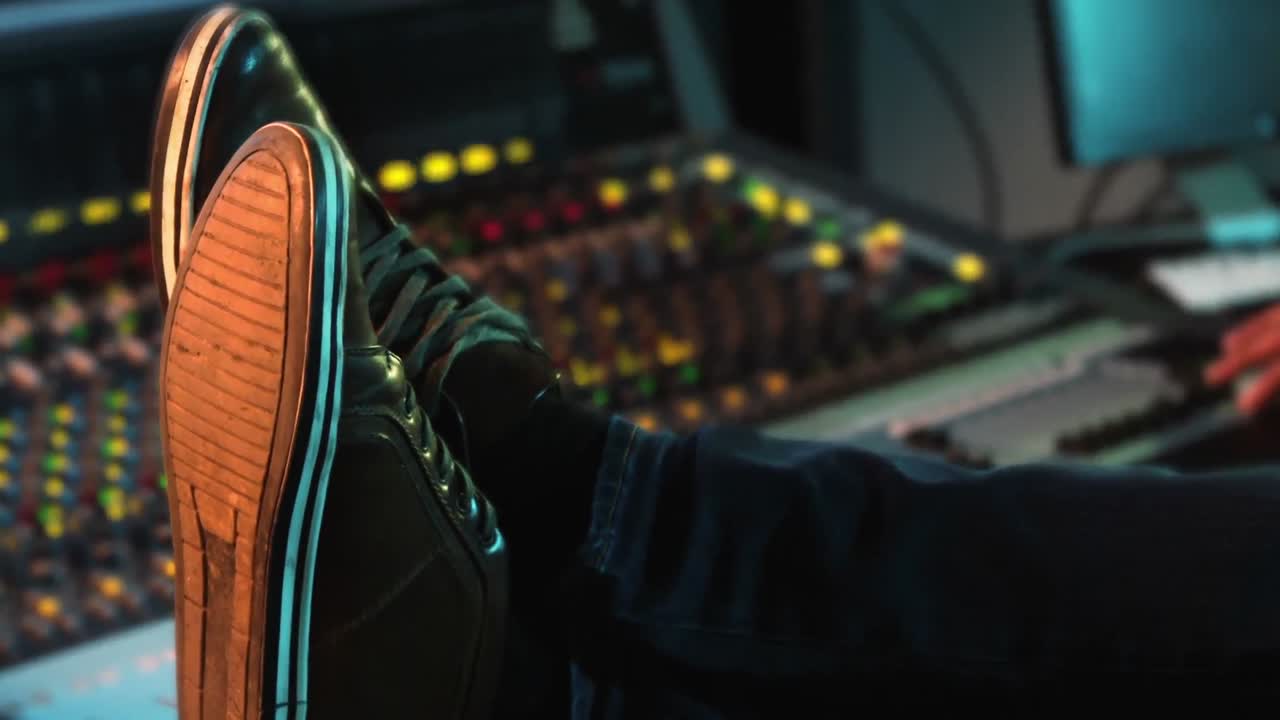 Audio engineer relaxing in recording studio