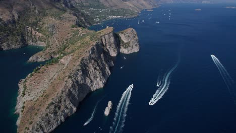 backward aerial view of a fabulous salerno gulf with the wake of speedboats. italy