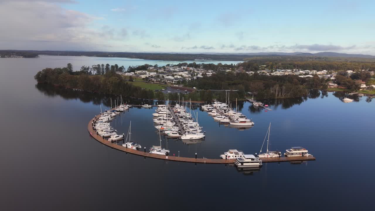 Aerial establishing of Trinity Point marina with boats docked in Morisset, New South Wales, pullback