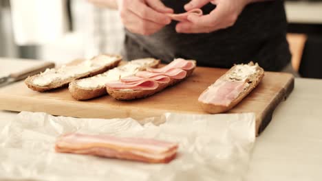 making a delicious bacon and cream cheese sandwich