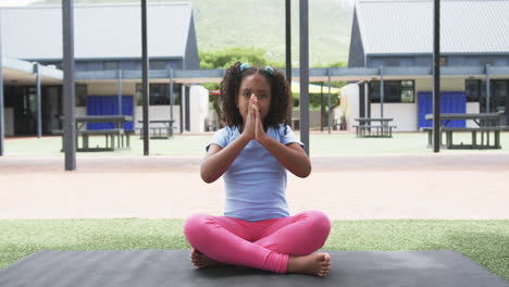 Biracial-Mädchen-In-Einer-Yoga-Pose-Auf-Einem-Schulhof