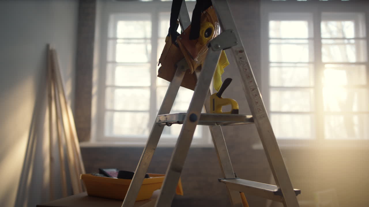 Ladder and building tools in new apartment. Do it yourself renovation concept.