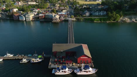 aerial shot flying over the pier in coupeville, wa to reveal the main street amenities