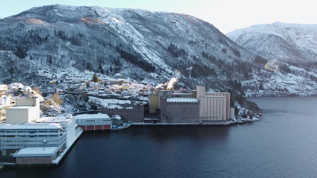 Factory Vaksdal Molle smoke from chimney during winter - Producing flour, grains and pet food