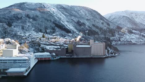 factory vaksdal molle smoke from chimney during winter - producing flour, grains and pet food