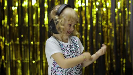 Child-dances,-sings,-listens-music-on-headphones.-Little-kid-girl-having-hun,-relaxing-and-enjoying
