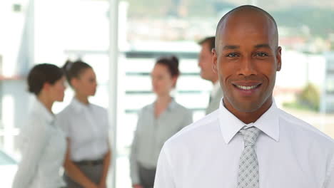 business man smiles while looking at the camera