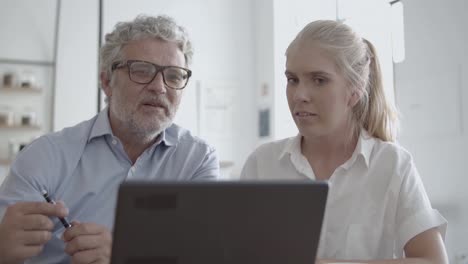 front view of ceo in glasses talking with female secretary