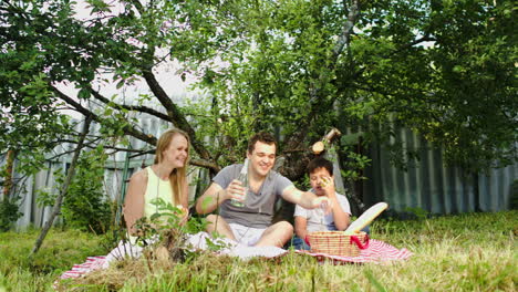 parents with their son having picnic in the courtyard