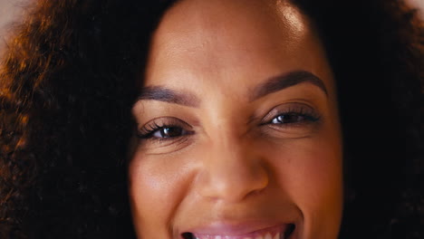 studio head and shoulders shot of laughing natural woman promoting body positivity