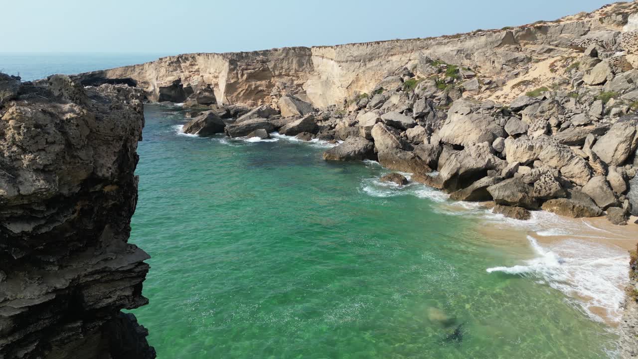 Stunning Aerial View of Rocky Coastline and Turquoise Ocean