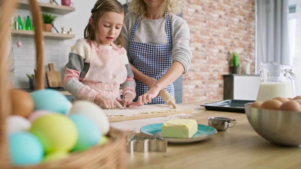 Tracking video of three generations of women preparing Easter cake