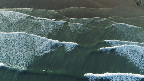 arial shot of coastal waves moving up the frame