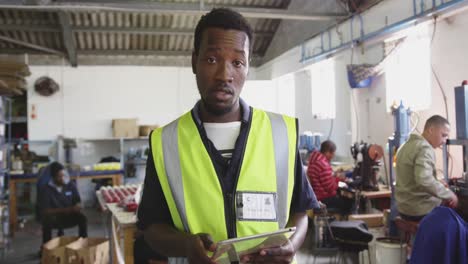 front view of mixed race worker in factory