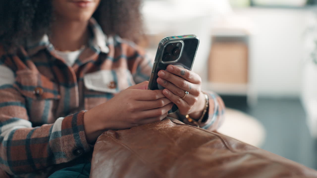 A woman sitting while using a phone
